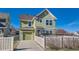 Exterior of green two-story house with attached garage and fenced backyard at 9435 E 108Th Pl, Commerce City, CO 80640