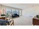 Spacious living room with a blue sofa, plenty of natural light, and neutral carpet at 9435 E 108Th Pl, Commerce City, CO 80640