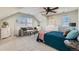 A tranquil bedroom retreat with a seating area, ceiling fan and natural light creating a cozy atmosphere at 9435 E 108Th Pl, Commerce City, CO 80640