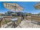 Back patio with table, chairs, umbrella, and barbeque at 9435 E 108Th Pl, Commerce City, CO 80640