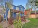 Two-story home with a backyard deck, pergola, and a well-maintained lawn creating an inviting outdoor space at 8793 Cloverleaf Cir, Parker, CO 80134