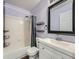 Bathroom featuring a shower-tub combo, shelves, large mirror and vanity at 8793 Cloverleaf Cir, Parker, CO 80134