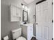 Well-lit bathroom with a modern vanity, a large mirror, and neutral gray wall paint at 8793 Cloverleaf Cir, Parker, CO 80134