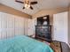 Cozy bedroom featuring a ceiling fan, a large dresser with a TV, and plenty of closet space at 8793 Cloverleaf Cir, Parker, CO 80134