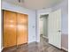 Bedroom featuring a closet with sliding doors and wood-look flooring at 8793 Cloverleaf Cir, Parker, CO 80134