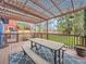 Deck featuring an overhead trellis, picnic table, string lights, and view of the backyard at 8793 Cloverleaf Cir, Parker, CO 80134