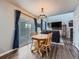 Inviting dining area with natural wood table, sliding glass door to patio, and an open view to the living room at 8793 Cloverleaf Cir, Parker, CO 80134
