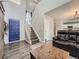 Entry foyer showcasing staircase, high ceilings, and wood floors leading into the living spaces at 8793 Cloverleaf Cir, Parker, CO 80134