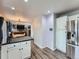 This kitchen features white cabinets, stainless steel appliances and access to the dining and living areas at 8793 Cloverleaf Cir, Parker, CO 80134