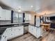 Bright kitchen showcases stainless steel appliances, ample white cabinetry, and a charming breakfast bar area at 8793 Cloverleaf Cir, Parker, CO 80134
