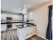 Well-lit kitchen features stainless steel appliances, white cabinets, and dark countertops for a modern aesthetic at 8793 Cloverleaf Cir, Parker, CO 80134
