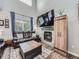 Living area featuring a fireplace, comfortable seating, large window, and cabinet at 8793 Cloverleaf Cir, Parker, CO 80134