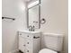 This modern half-bathroom features a stylish vanity with black hardware at 16273 E Brown Pl, Aurora, CO 80013