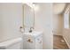 This bathroom features a single sink vanity with bronze hardware and a large mirror at 16273 E Brown Pl, Aurora, CO 80013