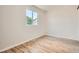 This bedroom is bright and spacious and features wood-look laminate flooring and a window at 16273 E Brown Pl, Aurora, CO 80013