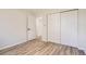 Bedroom with hardwood floors, closet with sliding doors and white doors with black hardware at 16273 E Brown Pl, Aurora, CO 80013