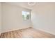 This bedroom is bright and spacious and features wood-look laminate flooring and a large window at 16273 E Brown Pl, Aurora, CO 80013