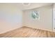 This bedroom is bright and spacious and features wood-look laminate flooring and a window at 16273 E Brown Pl, Aurora, CO 80013