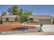 Inviting single-Gathering house featuring a manicured front yard, mature tree, and attached two-car garage at 16273 E Brown Pl, Aurora, CO 80013