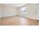 This spacious and bright living room features wood-look laminate flooring and a large picture window at 16273 E Brown Pl, Aurora, CO 80013