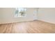 Inviting room featuring wood flooring, white trim and a large window offering natural light at 16273 E Brown Pl, Aurora, CO 80013