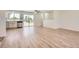 Bright, open-concept living space with wood floors, sliding glass doors to the backyard, and white trim at 16273 E Brown Pl, Aurora, CO 80013