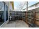 Private backyard featuring a wooden fence, utility hookups, and a patio area at 1865 Terry St # 3, Longmont, CO 80501