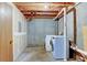 Unfinished basement area with washer and dryer hookups, perfect for storage or future expansion at 1865 Terry St # 3, Longmont, CO 80501