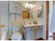 Bathroom with a white vanity, decorative artwork, a well-lit mirror, and ample storage at 1865 Terry St # 3, Longmont, CO 80501
