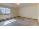 Cozy bedroom features carpeted floors and a window at 1865 Terry St # 3, Longmont, CO 80501