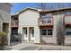 Charming townhome featuring a cozy balcony, well-maintained siding, and inviting entrances with clearly marked unit numbers at 1865 Terry St # 3, Longmont, CO 80501