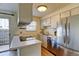 Clean kitchen with white cabinets, stainless steel appliances, and convenient backyard access at 1865 Terry St # 3, Longmont, CO 80501