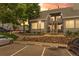 Charming condo complex with reserved parking, stone landscaping, and a welcoming entrance with stairs at 8500 E Jefferson Ave # 16B, Denver, CO 80237
