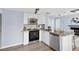 Updated kitchen with stainless steel appliances, granite countertops, and white cabinets at 8500 E Jefferson Ave # 16B, Denver, CO 80237