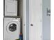 Convenient laundry area with stacked washer and dryer, next to a door at 8500 E Jefferson Ave # 16B, Denver, CO 80237
