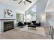 Cozy living room with high ceilings, a modern fireplace, large windows, and a comfortable seating area at 8500 E Jefferson Ave # 16B, Denver, CO 80237