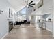 Open-concept living area with high ceilings, fireplace, and breakfast bar, blending style and functionality at 8500 E Jefferson Ave # 16B, Denver, CO 80237