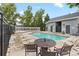 Community pool with lounge chairs, tables, and chairs for relaxing at 8500 E Jefferson Ave # 16B, Denver, CO 80237