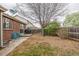Spacious backyard with mature trees, lawn, grill, and patio area at 2860 Calkins Pl, Broomfield, CO 80020