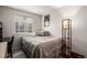 Cozy bedroom features a comfortable bed, window, and stylish floor lamp at 2860 Calkins Pl, Broomfield, CO 80020