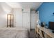 Well-lit bedroom with double closet, blue accent wall and neutral decor at 2860 Calkins Pl, Broomfield, CO 80020