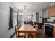 Bright dining area with a wooden table, four chairs, a window, and view into the kitchen at 2860 Calkins Pl, Broomfield, CO 80020