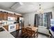 Eat-in kitchen featuring an adjacent dining area with a wooden table set and natural light from a window at 2860 Calkins Pl, Broomfield, CO 80020