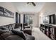 Comfortable living room with a plush sofa, neutral carpet, and sliding glass doors to the backyard at 2860 Calkins Pl, Broomfield, CO 80020