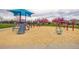 Community playground with swings, slides, and play structures for children at 2860 Calkins Pl, Broomfield, CO 80020