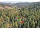 Stunning aerial view of wooded neighborhood with homes scattered throughout the trees at 26378 S End Rd, Kittredge, CO 80457