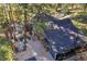 Aerial view of the property with a backyard patio and stacked firewood, surrounded by trees at 26378 S End Rd, Kittredge, CO 80457