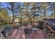 Scenic backyard with a wooden deck, metal railings, and tall pine trees at 26378 S End Rd, Kittredge, CO 80457