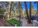 Backyard with a hammock strung between trees and a landscaped patio at 26378 S End Rd, Kittredge, CO 80457