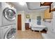 Functional bathroom with a vintage-style tub and stacked washer and dryer at 26378 S End Rd, Kittredge, CO 80457